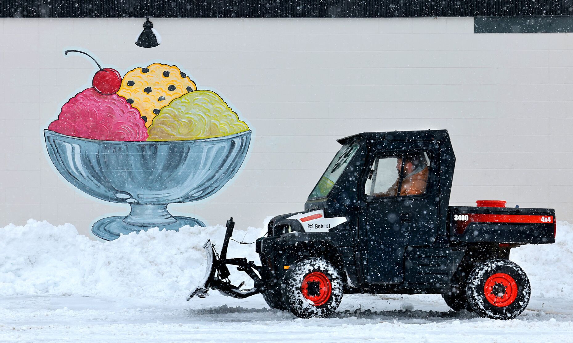 Customers reach the ice cream by first scooping away the ice